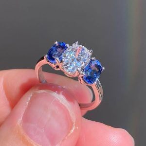 Three Stone Oval Cut White & Blue Sapphire Engagement Ring