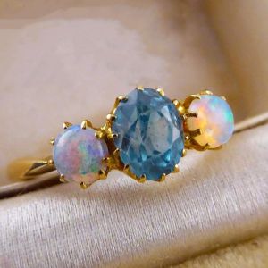 Golden Three Stone Oval Cut Blue Zircon & Opal Engagement Ring