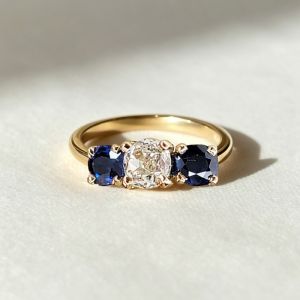 Golden Three Stone Cushion Cut White & Blue Sapphire Wedding Band For Women 
