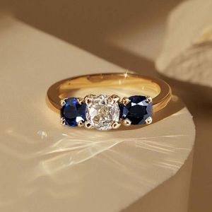 Golden Three Stone Cushion Cut White & Blue Sapphire Wedding Band For Women 